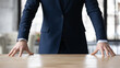 © fizkes - Crop close up of Caucasian businessman in formal suit stand at desk in office show confidence and power at workplace, hands of successful male leader or boss posing, leadership, success concept