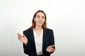 People clapping their hands during a meeting, congratulation and appreciation. Young attractive woman with brown hair in light t-shirt, black jacket on white background