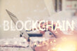 © peshkova - Double exposure of woman hands typing on computer and crypto market theme hologram drawing. Blockchain concept.