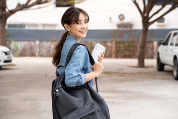 Portrait of young Asian woman student with coffee and backpack