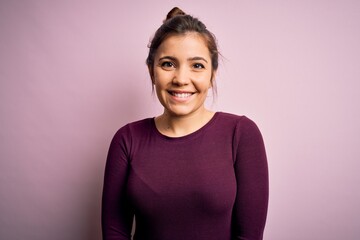 Poster - Beautiful young woman wearing casual bun hairstyle over pink isolated background with a happy and cool smile on face. Lucky person.