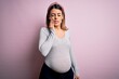 Young beautiful brunette woman pregnant expecting baby over isolated pink background touching mouth with hand with painful expression because of toothache or dental illness on teeth. Dentist
