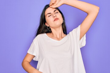 Sticker - Young beautiful brunette woman wearing casual white t-shirt over purple background stretching back, tired and relaxed, sleepy and yawning for early morning