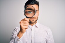 Young Detective Man Looking Through Magnifying Glass Over Isolated Background With A Confident Expression On Smart Face Thinking Serious