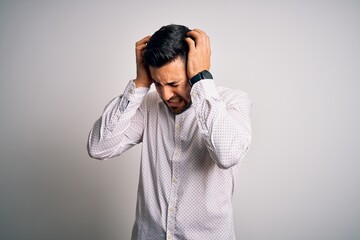 Sticker - Young handsome man wearing elegant shirt standing over isolated white background suffering from headache desperate and stressed because pain and migraine. Hands on head.