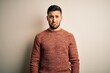 © Krakenimages.com - Young handsome man wearing casual sweater standing over isolated white background depressed and worry for distress, crying angry and afraid. Sad expression.