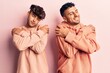 © Krakenimages.com - Young gay couple wearing casual clothes hugging oneself happy and positive, smiling confident. self love and self care