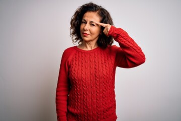 Sticker - Middle age brunette woman wearing casual sweater standing over isolated white background pointing unhappy to pimple on forehead, ugly infection of blackhead. Acne and skin problem