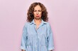 © Krakenimages.com - Middle age beautiful woman wearing casual denim shirt standing over pink background depressed and worry for distress, crying angry and afraid. Sad expression.