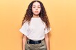 © Krakenimages.com - Beautiful kid girl with curly hair wearing casual clothes with serious expression on face. simple and natural looking at the camera.