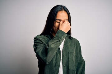 Canvas Print - Young beautiful asian woman wearing casual shirt standing over isolated white background tired rubbing nose and eyes feeling fatigue and headache. Stress and frustration concept.