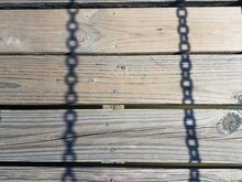 Wood Boards With Shadows Of Metal Chains