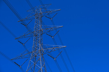 Electrical tower station wiring power with clearly blue sky background, High voltage station post