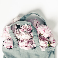Wall Mural - blue cotton eco tote bag with peony flowers on white background with copy space