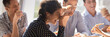 © fizkes - Laughing indian businesswoman in friends company eating pizza enjoy lunch together with colleagues, team building corporate party, friendship concept. Horizontal photo banner for website header design