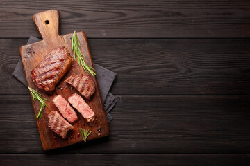 Wall Mural - Grilled beef steaks on cutting board