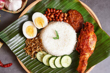 "Nasi Lemak" Is A Malay Fragrant Rice Dish Cooked In Coconut Milk And Pandan Leaf. It Is Commonly Found In Malaysia. This Nasi Lemak With Extra Dish Spices Fried Chicken.
