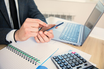 Canvas Print - man hand phone in working desk