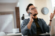 © JustLife - Businessman in office. Handsome man talking on phone at work.