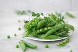 Fototapeta Mapy - fresh green peas with greens and pea pods
