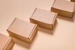 © mdbildes - Lot of square cardboard boxes on beige background