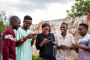 Poster - a group of young africans using their phones, hanging out together, students leisure on campus, laughing and having a good time