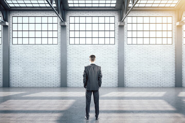 Sticker - Businessman standing in contemporary warehouse interior