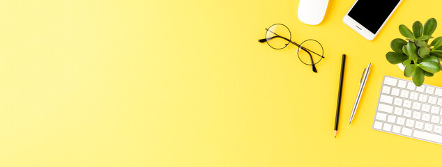 office desktop with accessories on yellow table. business background. banner