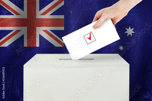 Australian Vote concept. Voter hand holding ballot paper for election vote on polling station