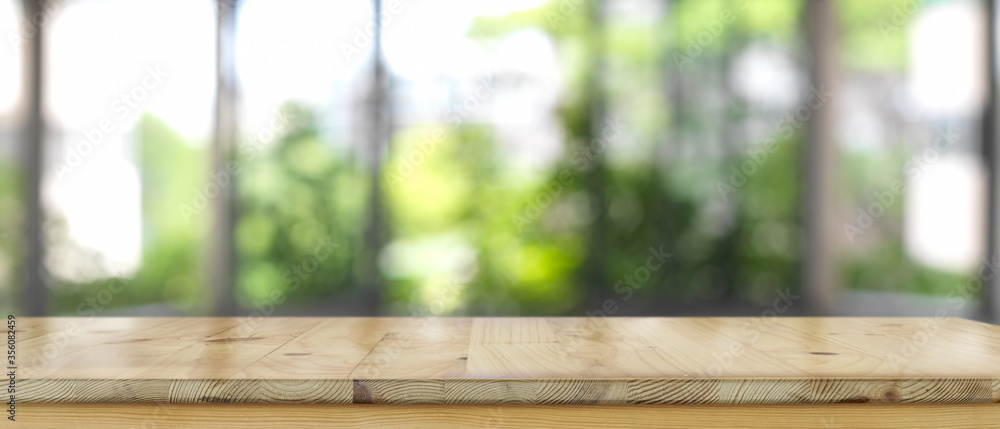 Empty wooden counter bar, wooden table with blurred backyard background - obrazy, fototapety, plakaty 