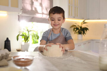 Sticker - Cute little boy with dough at table in kitchen. Cooking pastry