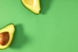 Avocado minimal pattern. Border made of green avocado on light green background. Flat lay, top view, copy space