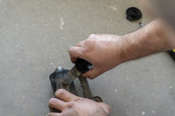 Wall Mural - Auto mechanic works in the garage. Repairs. Disassembly of the trapezoid wiper. Diagnostics