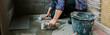 © David Pereiras - Female mason laying a new tile floor on a terrace
