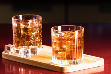 Whiskey glasses with ice in a lounge bar