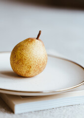 yellow pear on a white plate