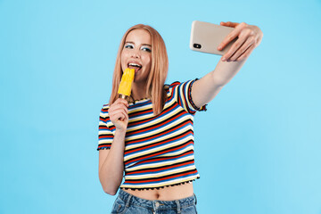 Sticker - Image of pretty girl eating ice-cream and taking selfie on cellphone