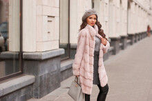 Elegant Rich Woman In Pink Fur Coat And Gray Beret Walking City Street. Outdoor Life Style Portrait Of Fashionable Lady