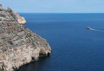 Nice Blue Grotto view in Malta island with two boat in the clear blue sea, touristic destination in Malta, Blue Grotto, tour in Blue Grotto in Malta, popular place in Malta,nice Malta,