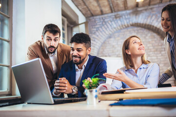 Startup business team on meeting in modern bright office interior brainstorming, working on computer