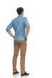 © Viorel Sima - back view of concerned casual guy holding hands on hips