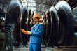 Worker checks turbine impeller vanes on factory