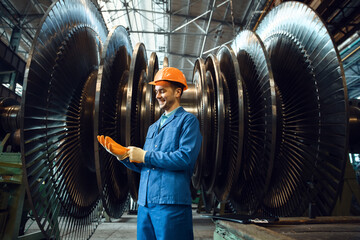 Poster - Worker checks turbine impeller vanes on factory