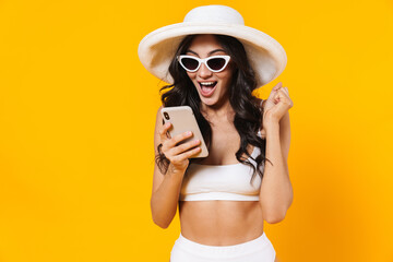 Poster - Image of amazed woman making winner gesture and using cellphone