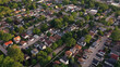 Aerial view of american suburb at summertime.  Establishing shot of american neighborhood. Real estate, residential houses. Drone shot, from above