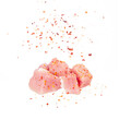 Sliced raw meat pork sprinkled with seasoning on a white background