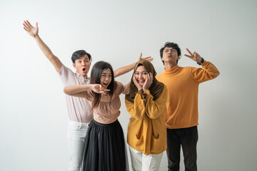 group of young Asian people happy to celebrate when looking at the camera with an isolated background