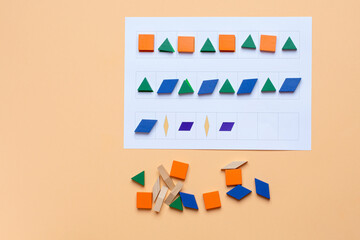 A game. Lay out wooden blocks according to the shape, color indicated in the table. The development of thinking, attention, quick wit, imagination