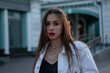 © Алексей Дегтярев - Portrait of a fashionable brunette. Long dark hair and bright red lipstick. The girl looks at the camera
