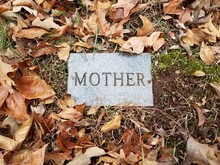Grave Stone Or Marker With Mother And Fallen Leaves